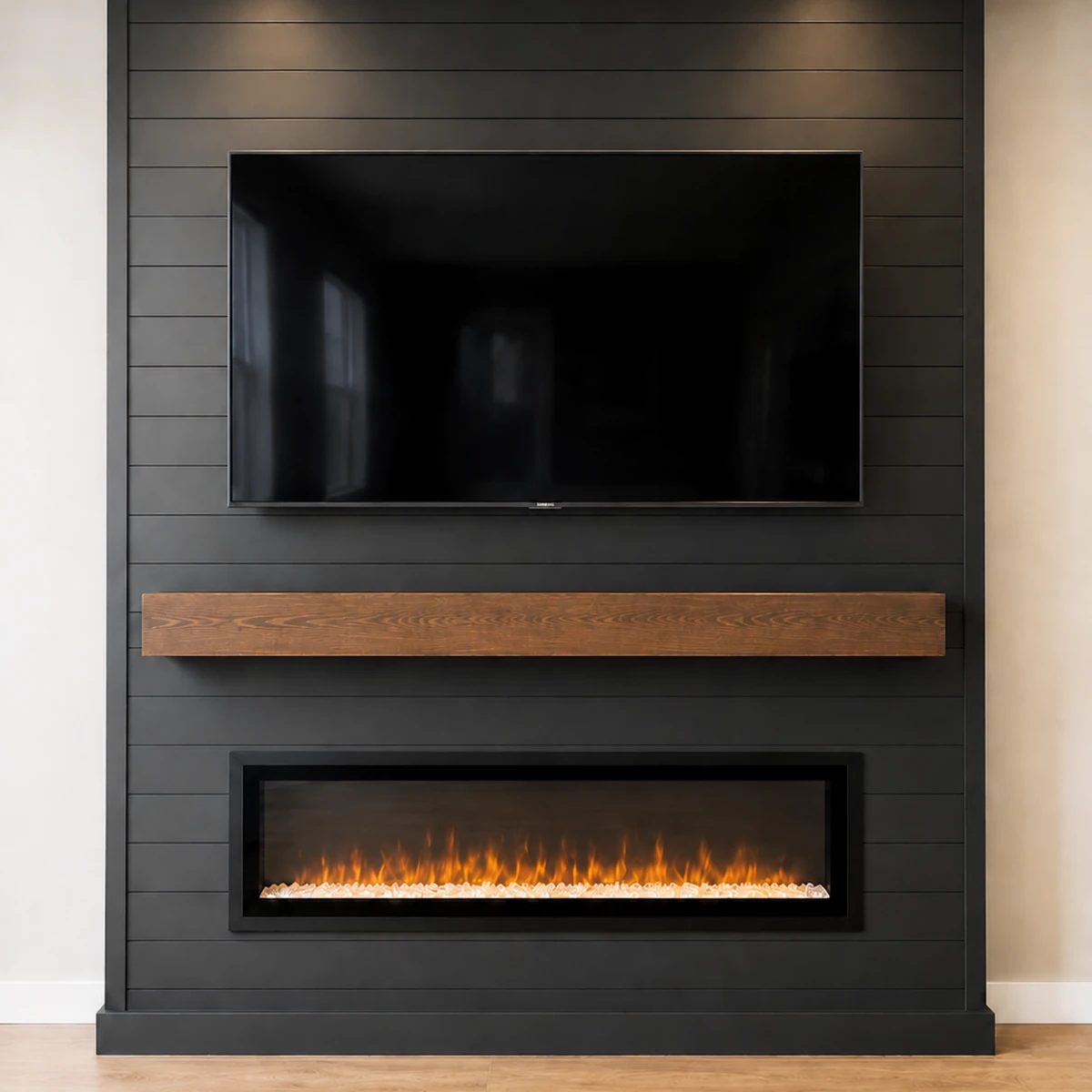 Black shiplap fireplace feature wall with mounted television, wood mantel, and linear electric fireplace